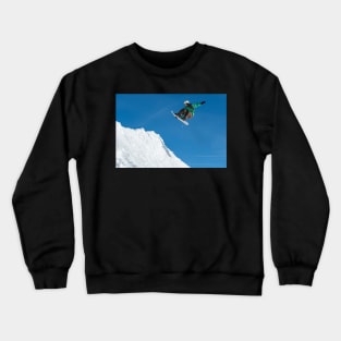 Snowboarder jumping against blue sky Crewneck Sweatshirt
